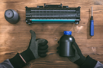 Computer technician engineer is refilling a laser toner cartridge. Office equipment maintenance...