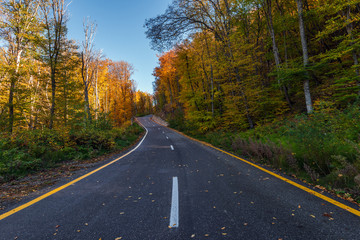 Fototapeta na wymiar Highway in the autumn mountain forest