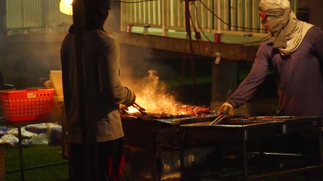 Cooks barbequing at Chamorro Village, Guam. Which is held every Wednesday night that attracts tons of tourists and locals with delicious local food.