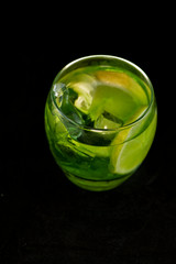 Green cocktail with gin, bitter lemon, basil and lemon
