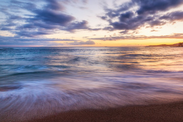 Evening Sunset at a Tropical Rocky Beach