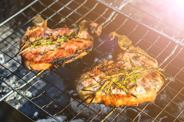 Steaks cooking on grill for summer outdoor party. Food background with barbecue party, front view