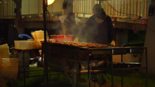 Cooks barbequing at Chamorro Village, Guam. Which is held every Wednesday night that attracts tons of tourists and locals with delicious local food.