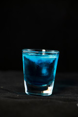 Jellyfish shot cocktail with blue curacao, sambuca, vodka and milk