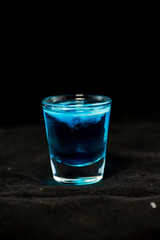 Jellyfish shot cocktail with blue curacao, sambuca, vodka and milk