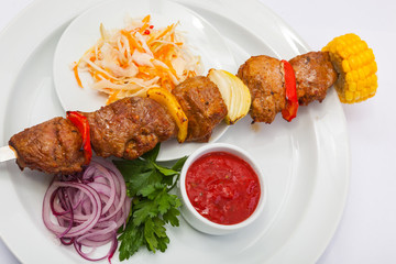 shashlik on skewer with red sauce