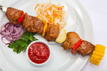 shashlik on skewer with red sauce