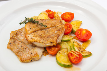 Fried fish on vegetables
