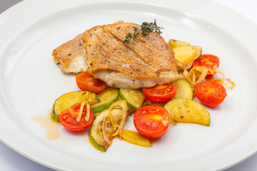 Fried fish on vegetables