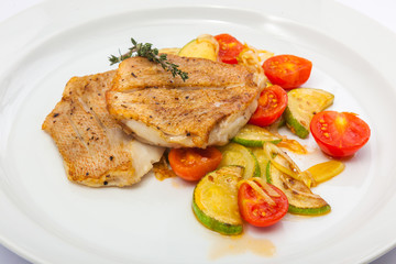Fried fish on vegetables
