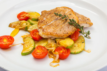 Fried fish on vegetables