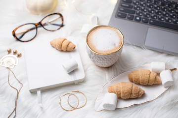 Lady bloggers white work place with business details, laptop, co