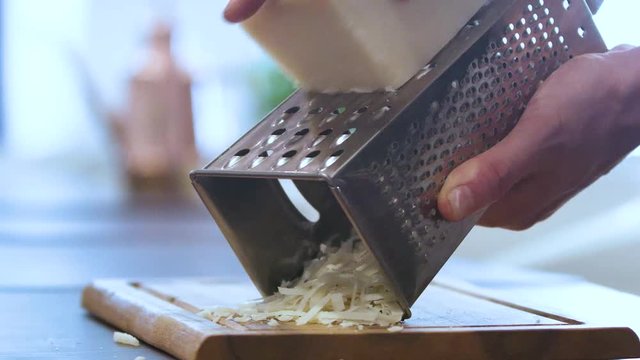 Italian Chef grate cheese.