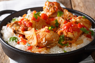 Haitian Chicken Recipe is a one pot of chicken, tomatoes, wine, spices, and rice close-up....