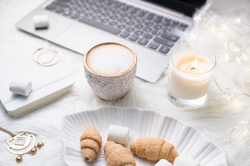 Lady bloggers white work place with business details, laptop, co