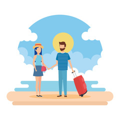 young couple with suitcase on the beach