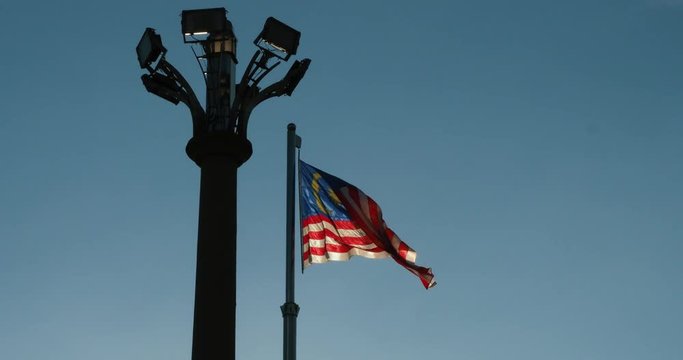 Malaysian Flag waving next to lighting