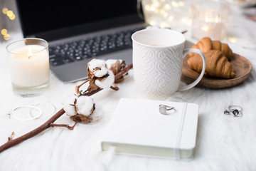 Lady bloggers white work place with business details, laptop, co