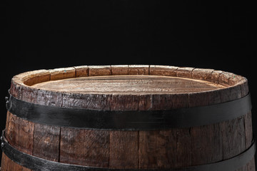Fototapeta premium Old wooden barrel on a dark background