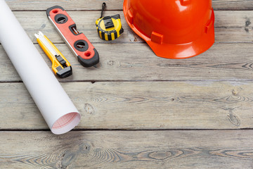 Construction  worker supplies and instruments on wooden background