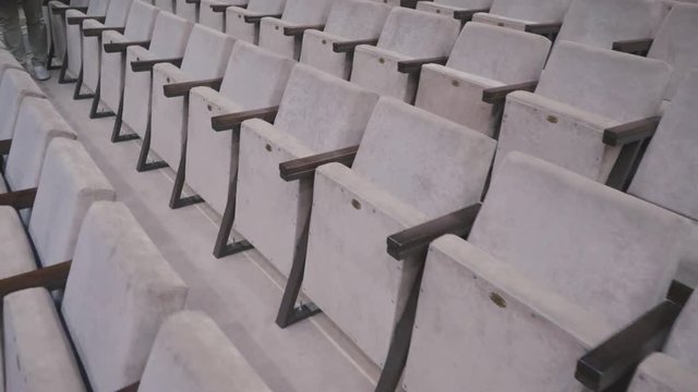 Gray chairs in an empty cinema hall. Empty chairs. The failure of the film at the box office. Concert hall without spectators and fans. The night before the premiere performance. Studio TV show