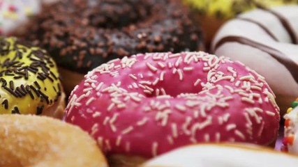 assorted donuts with different fillings and icing. Dolly video