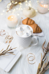 Cozy winter bloggers white work space with laptop, coffee with m