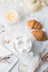 Cozy winter bloggers white work space with laptop, coffee with m