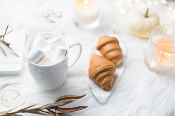 Cozy winter bloggers white work space with laptop, coffee with m