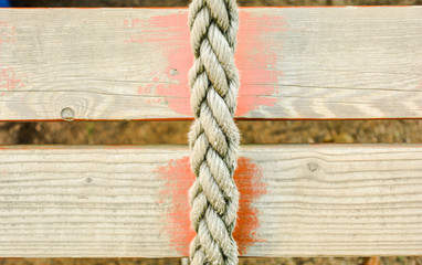 Fototapeta premium Old rope and distressed red painted wood planks