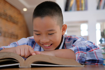 Fototapeta premium little asian kid boy child children studying reading book.