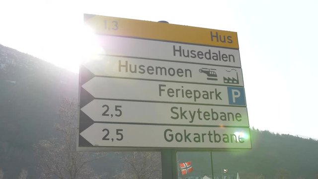 Road Sign in Kinsarvic, Norway with a Lens Flare from the Setting Sun