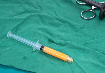 fat syringes on the green surgical drapes for fat grafting or fat transfer procedure
