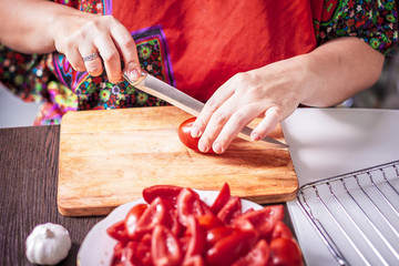preparing sun dried tomatoes, woman slicing tomato
