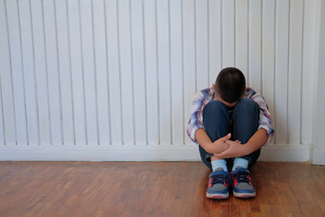 depressed upset sad asian kid boy child children sitting on floor