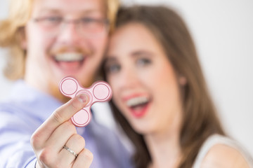 Couple playing with fidget spinner