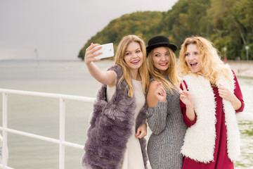 Three women taking selfie outdoor