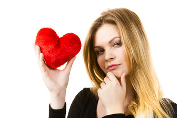 Woman thinking about love holding heart