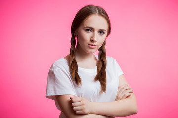 Fototapeta premium Closeup portrait of young teen girl with pigtails on pink background