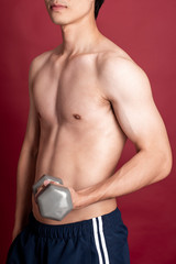 Naklejka premium Fitness man on red background