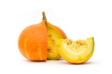 Orange Japanese Pumpkin fruit with cut out to see the flesh in yellow and seeds for to see the freshness and nice to eat on white blackground.