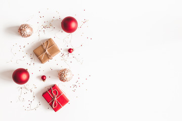 Christmas composition. Christmas gifts, red and golden decorations on white background. Flat lay,...