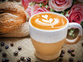 Decoration of cappucino coffee with bread and beans.