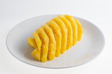 peeled pineapple on white plate
