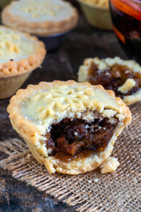 Traditional Christmas mince pies and mulled wine on wooden table