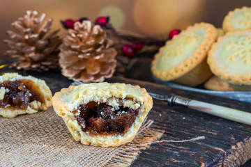 Traditional Christmas mince pies on wooden table