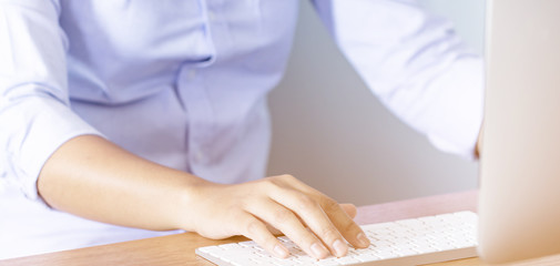 Fototapeta premium Lady working at home with computer,Her hand holding pen writing a blog and Creative idea of work 2019 goals, writing, drawing, making notes in document Business,investment,concept,Soft focus.