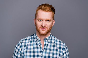 Close-up portrait of sad displeased handsome attractive trendy m