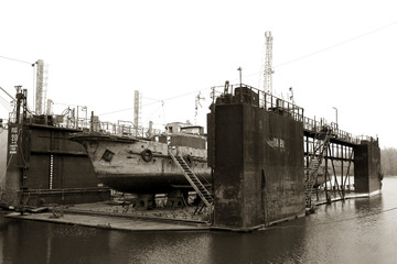 Ust-Dunaisk, Odessa, Ukraine - 2008: Archival photo. River port was destroyed in crisis. Old river ships rust at dock repair shops stocks for repairing riverboats. Rusty boats on stocks in dry dock