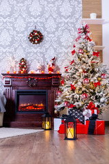 Colorful presents under Christmas tree in decorated room. The joy of Christmas.